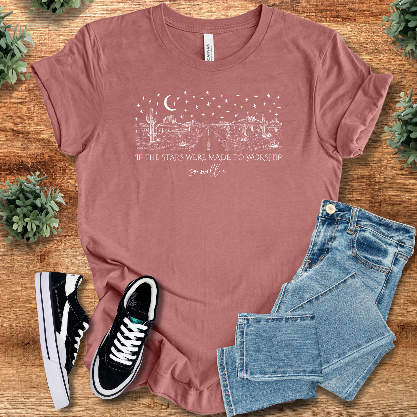 Heather-aqua t-shirt with '' text, flat lay styled on a wooden surface.