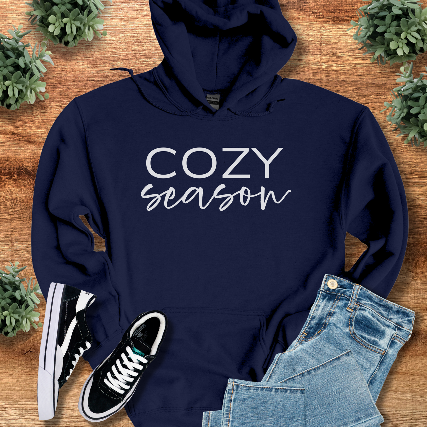 Royal t-shirt with '' text, flat lay styled on a wooden surface.