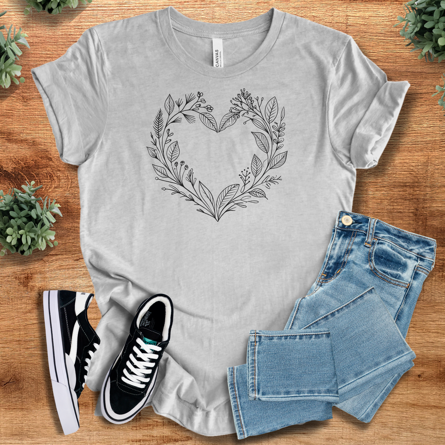 Soft-cream t-shirt with '' text, flat lay styled on a wooden surface.