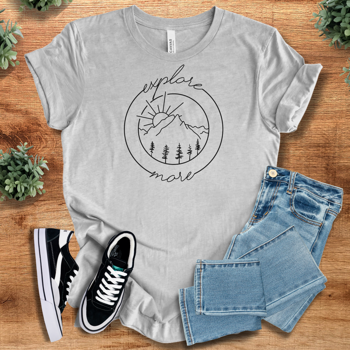Heather-mauve t-shirt with '' text, flat lay styled on a wooden surface.