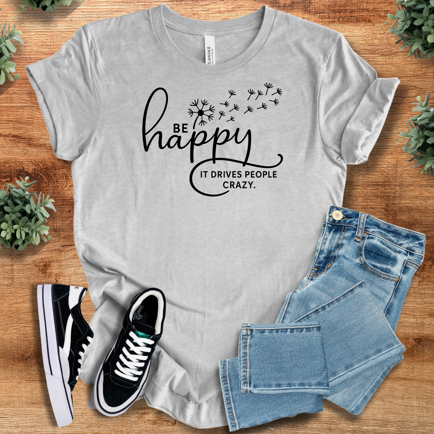 Heather-mauve t-shirt with '' text, flat lay styled on a wooden surface.