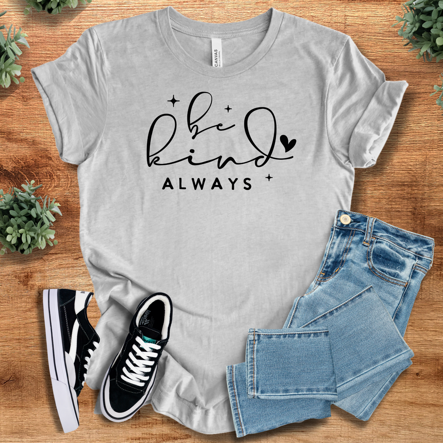 Heather-aqua t-shirt with '' text, flat lay styled on a wooden surface.