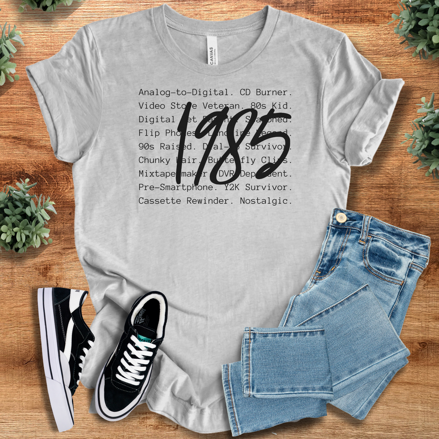 Athletic-heather t-shirt with '' text, flat lay styled on a wooden surface.