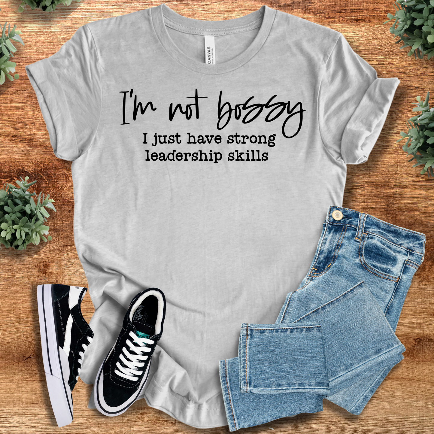 athletic gray t-shirt with '' text, flat lay styled on a wooden surface.