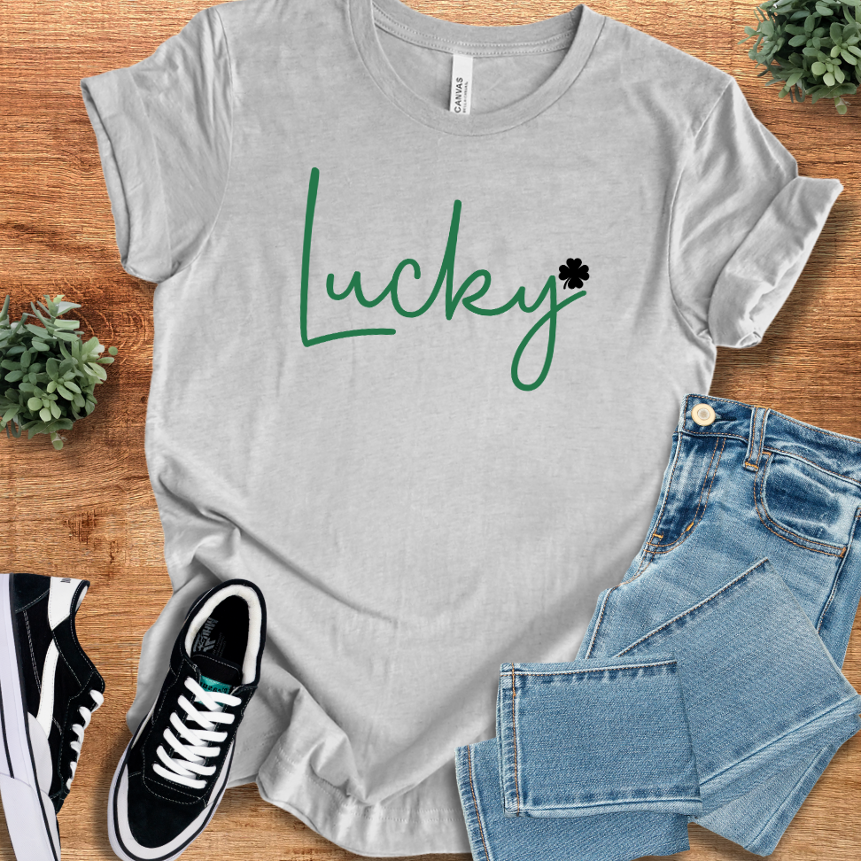 Athletic Heather t-shirt with 'Lucky Classic T‑Shirt' text, flat lay styled on a wooden surface.
