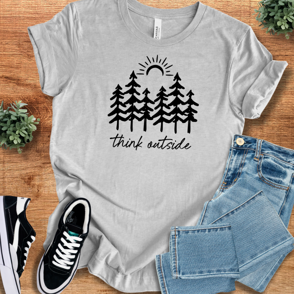 Athletic-heather t-shirt with 'Think Outside T‑Shirt' text, flat lay styled on a wooden surface.