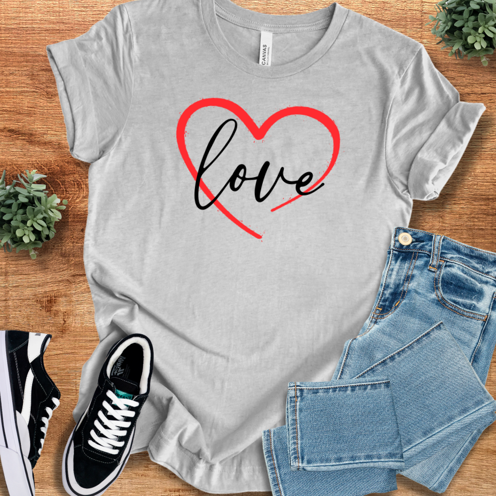 Athletic Heather t-shirt with 'Valentine Love Heart T‑Shirt' text, flat lay styled on a wooden surface.