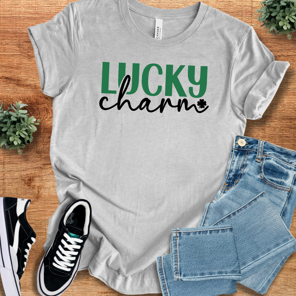 Athletic Heather t-shirt with 'Lucky Charm T‑Shirt' text, flat lay styled on a wooden surface.