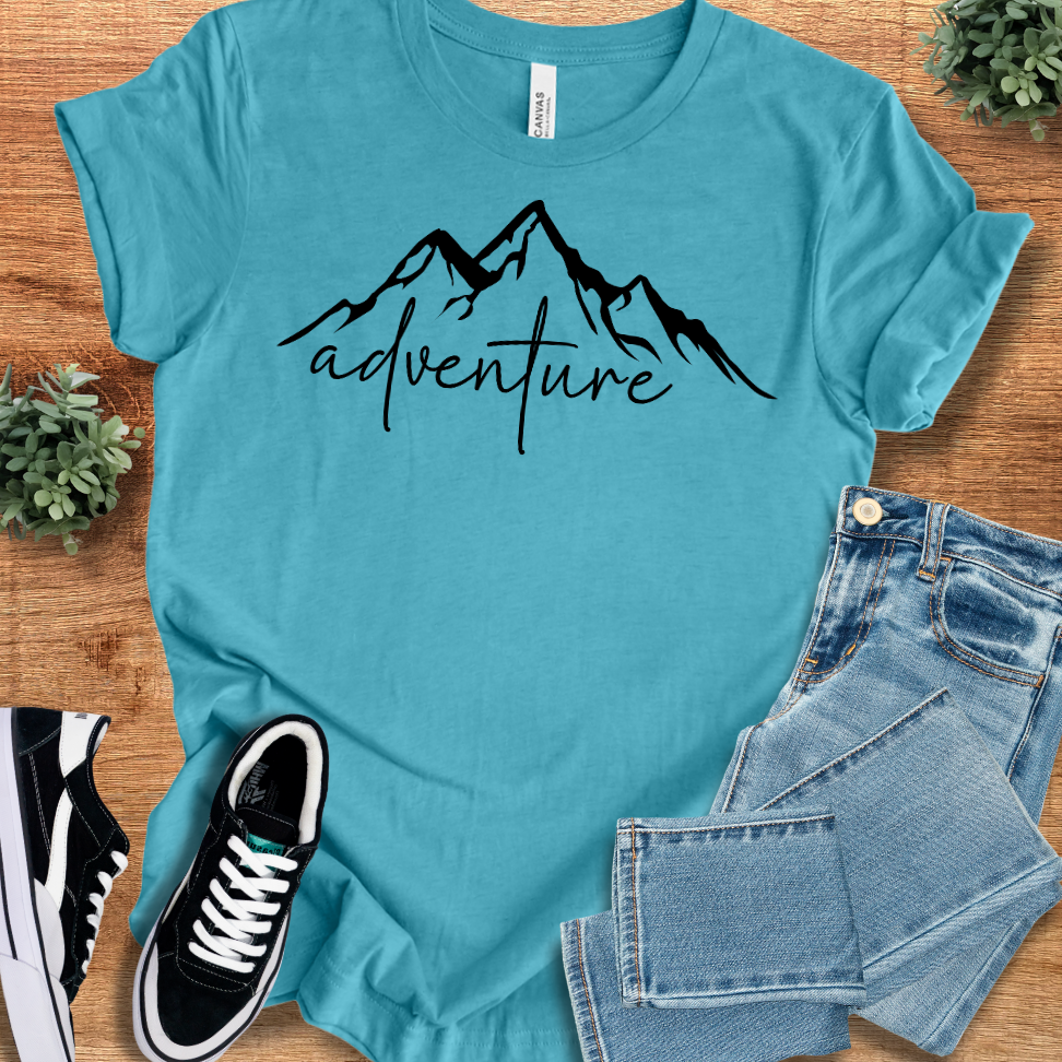Heather-aqua t-shirt with '' text, flat lay styled on a wooden surface.