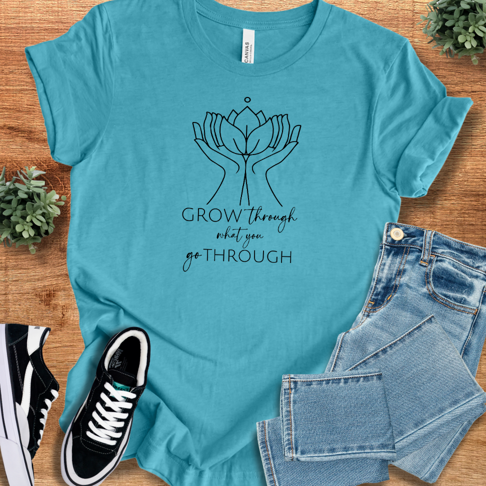 Athletic-heather t-shirt with '' text, flat lay styled on a wooden surface.