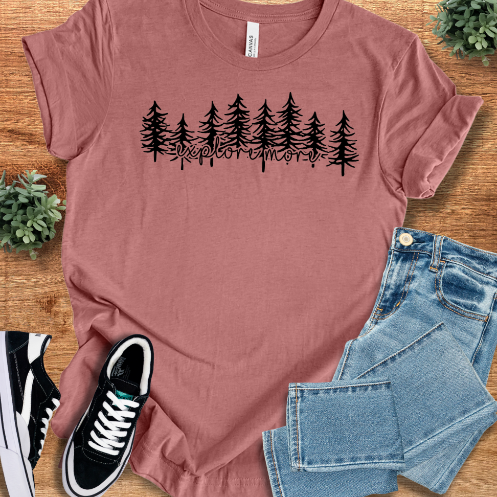 Heather-mauve t-shirt with '' text, flat lay styled on a wooden surface.