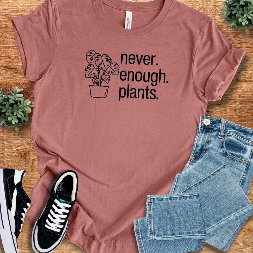 Heather-mauve t-shirt with '' text, flat lay styled on a wooden surface.
