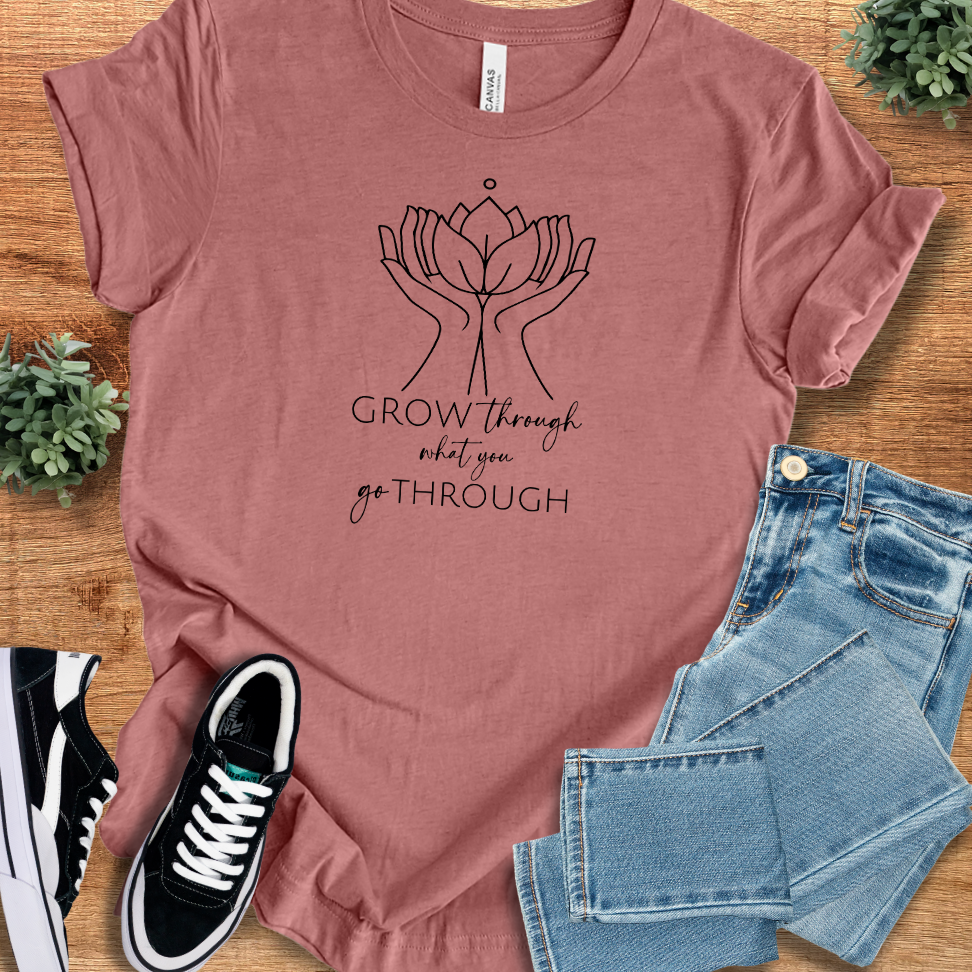 Athletic-heather t-shirt with '' text, flat lay styled on a wooden surface.