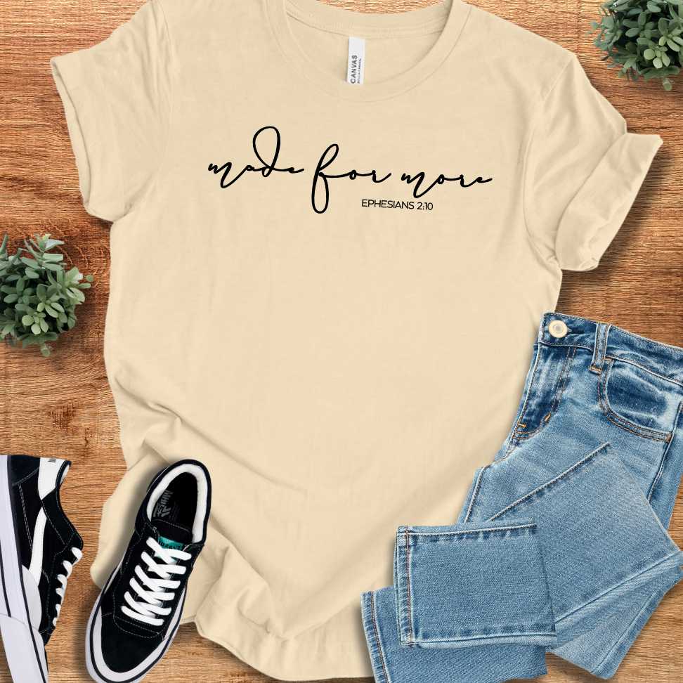 Heather-mauve t-shirt with '' text, flat lay styled on a wooden surface.