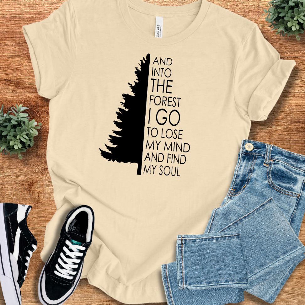 Heather-mauve t-shirt with '' text, flat lay styled on a wooden surface.