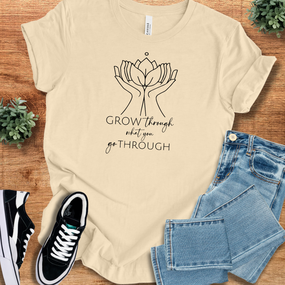 Athletic-heather t-shirt with '' text, flat lay styled on a wooden surface.