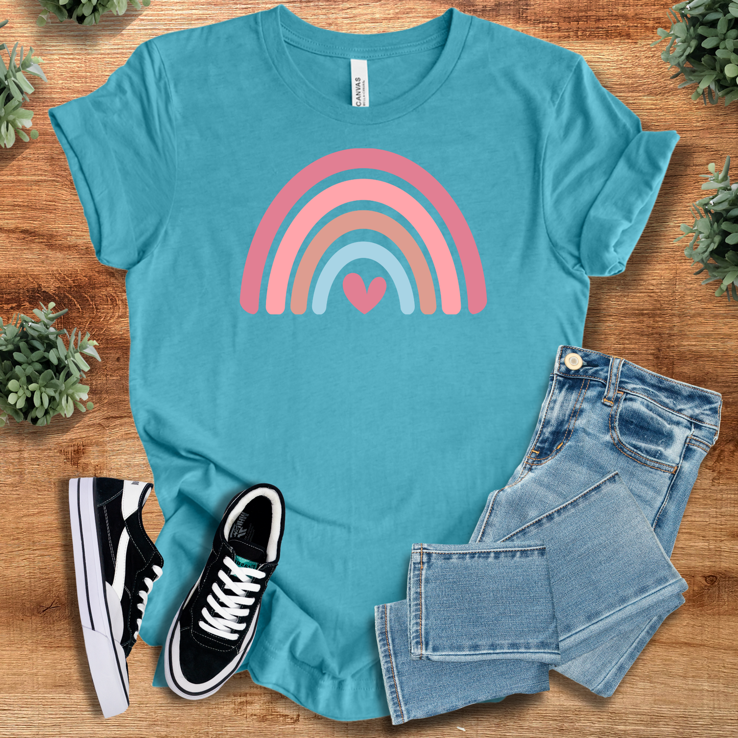 Heart Rainbow Tee in teal blue with a vibrant pink and blue rainbow heart print. Comfortable cotton T-shirt perfect for pride and positivity.