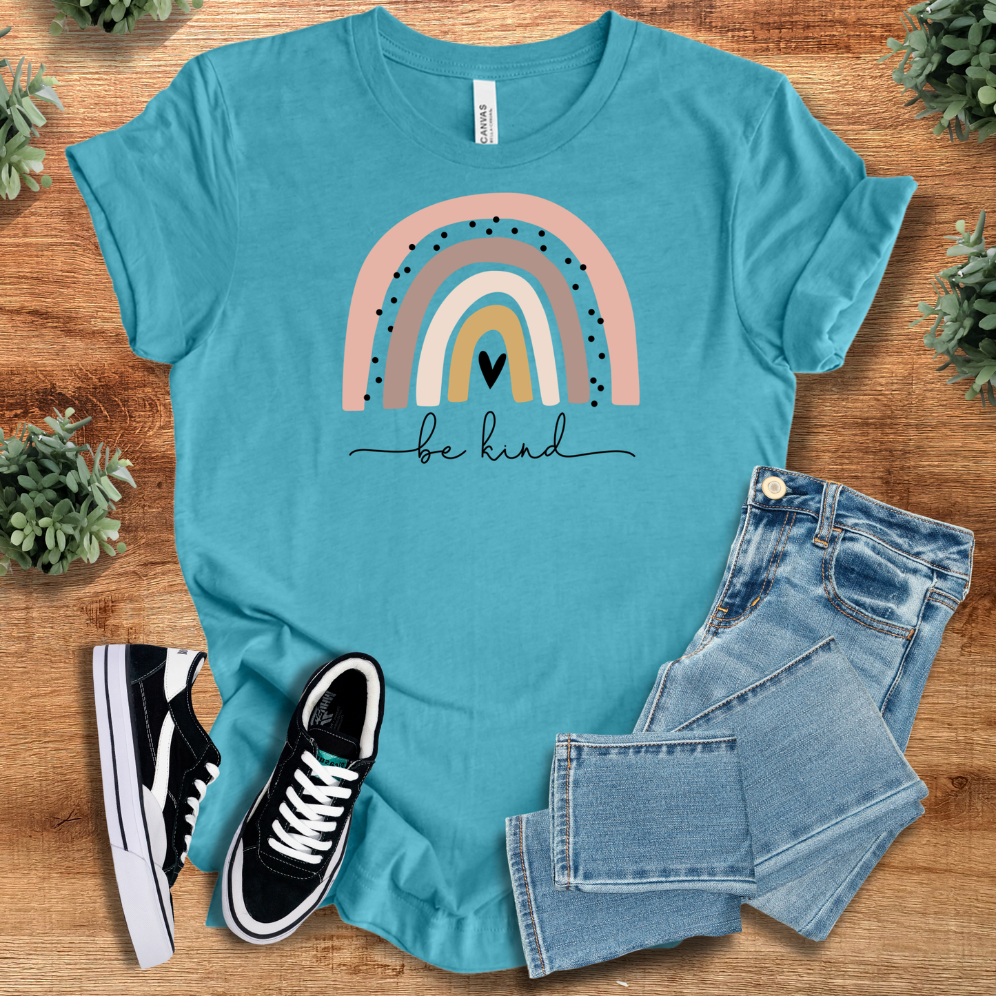 Teal Rainbow Be Kind Tee with uplifting rainbow and heart print, breathable 100% cotton T-shirt perfect for weekend outfits and positive vibes.