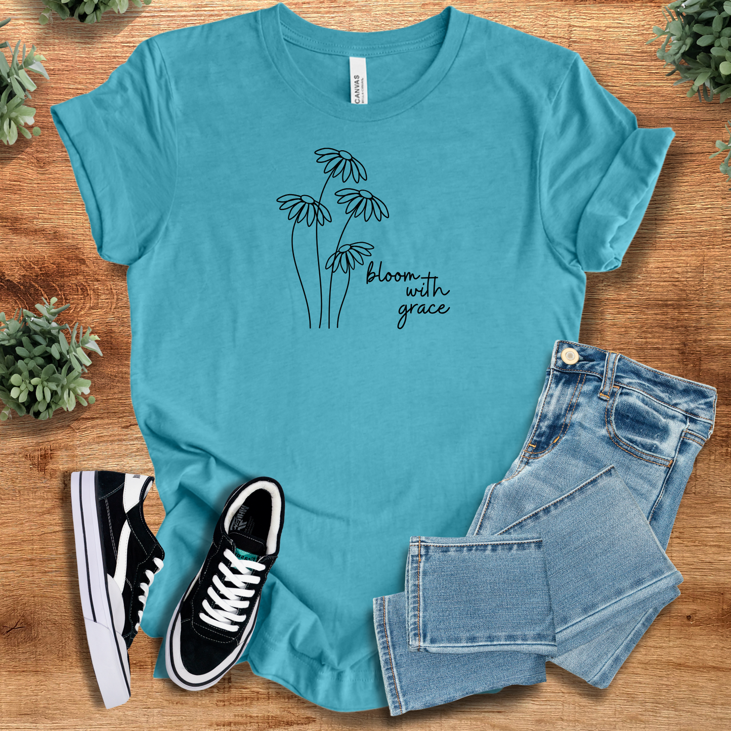 Heather-mauve t-shirt with '' text, flat lay styled on a wooden surface.