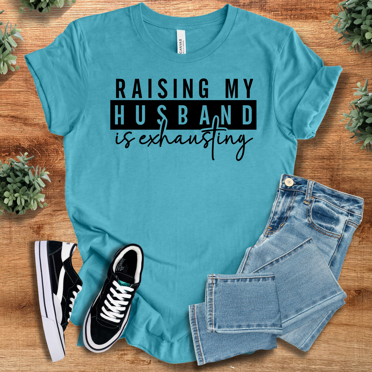 Athletic-heather t-shirt with '' text, flat lay styled on a wooden surface.