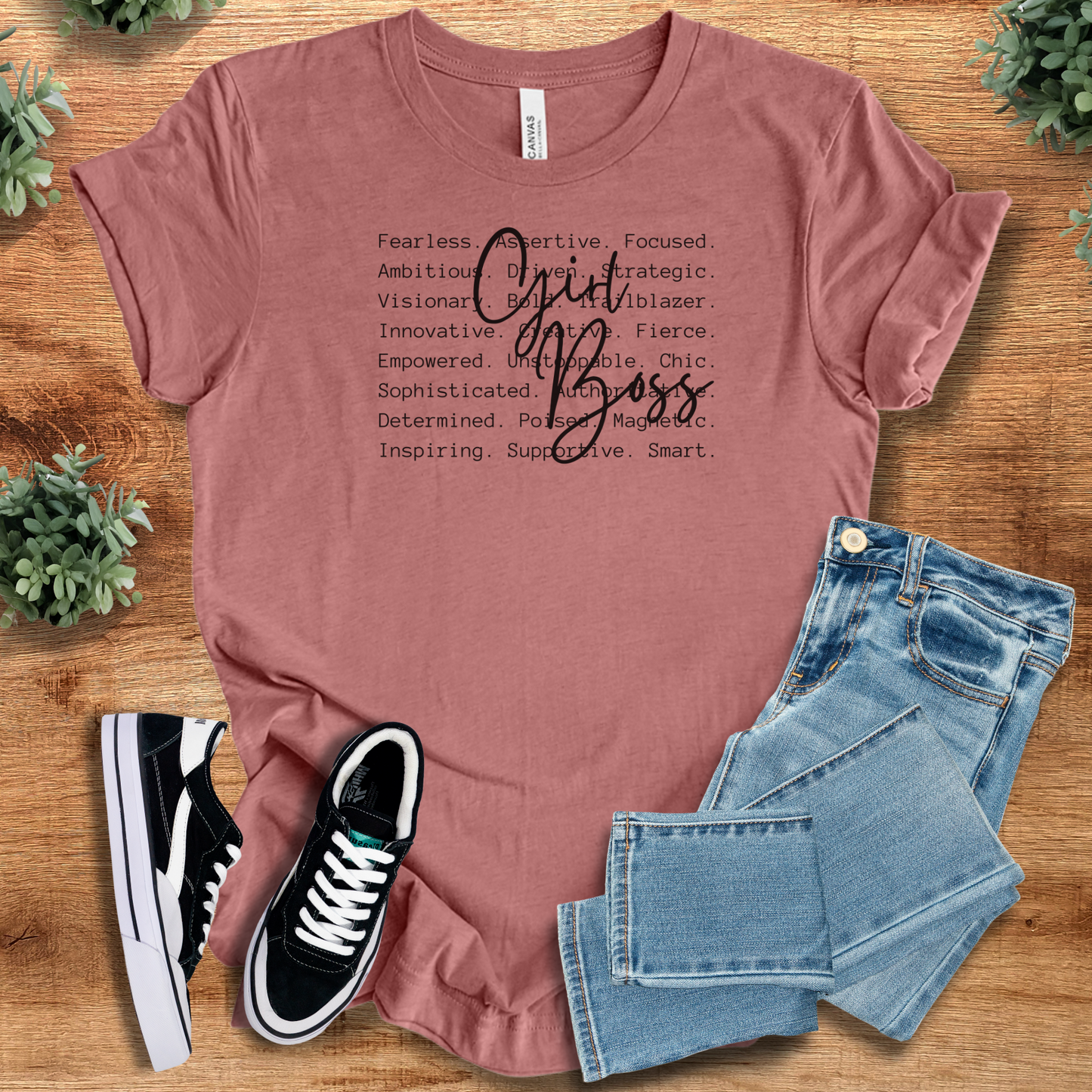 Sage t-shirt with '' text, flat lay styled on a wooden surface.