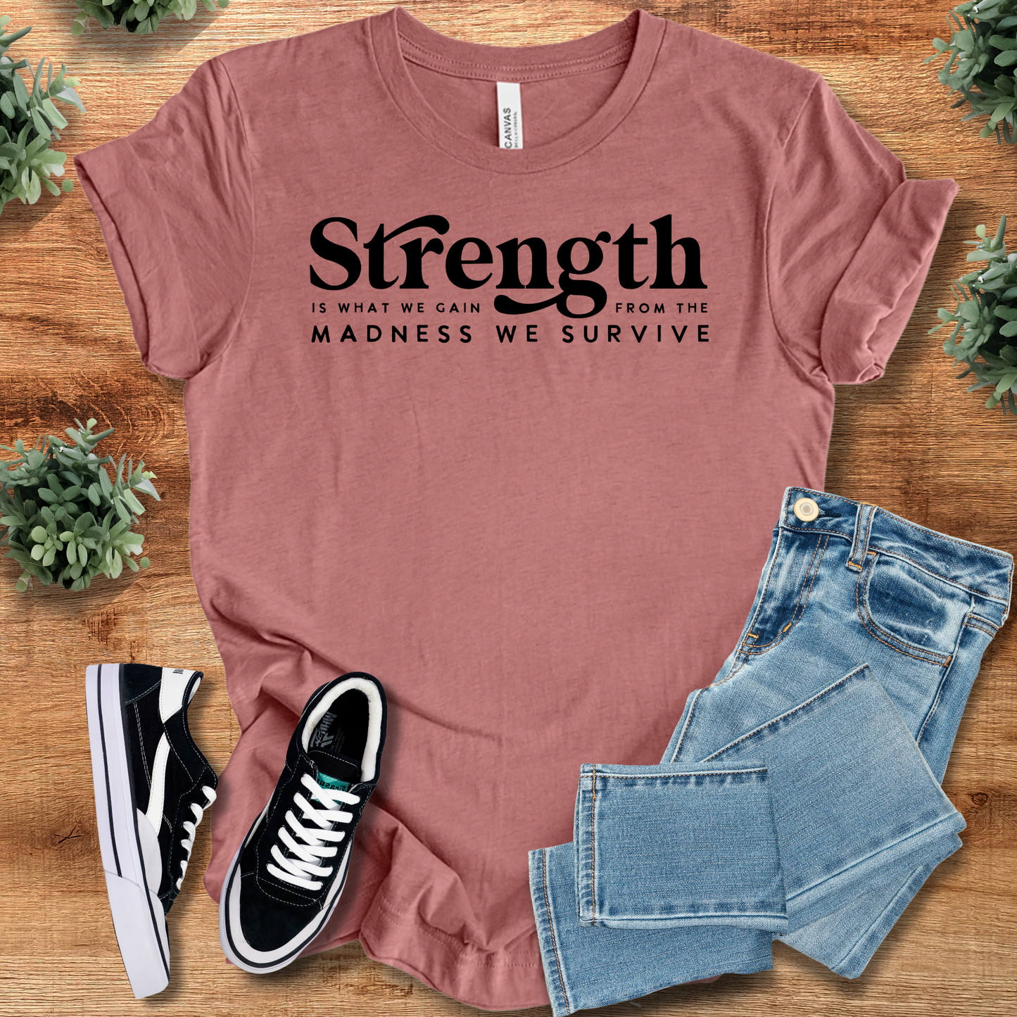 Mauve pink unisex strength tee with inspirational quote, styled with denim and sneakers. Empowerment apparel perfect for casual self-care looks.