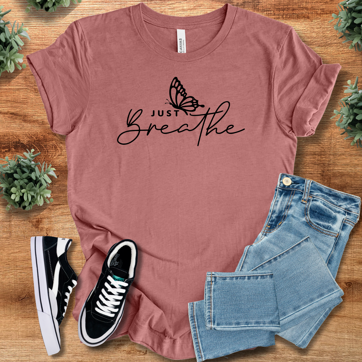 Mauve Just Breathe Tee T‑Shirt on Bella+Canvas 3001 featuring minimalist butterfly design, paired with denim and sneakers.