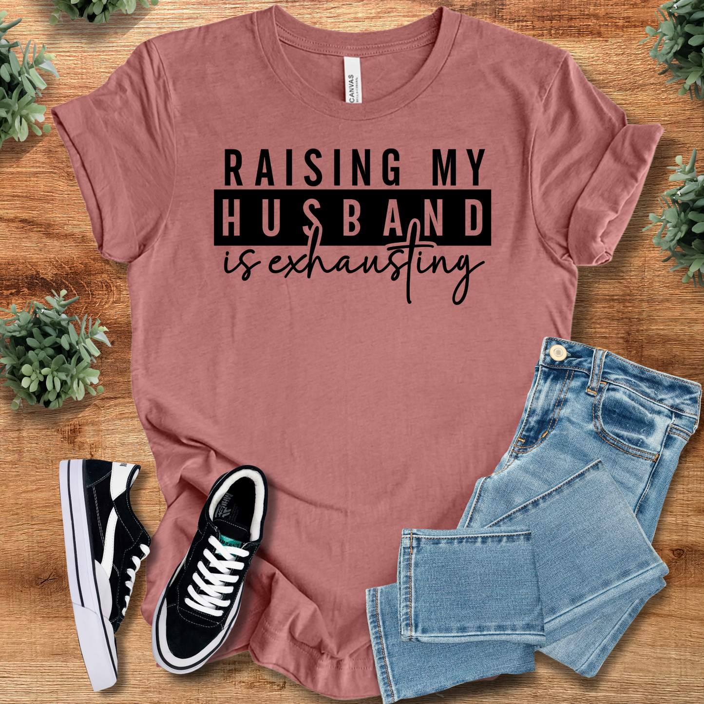 Athletic-heather t-shirt with '' text, flat lay styled on a wooden surface.