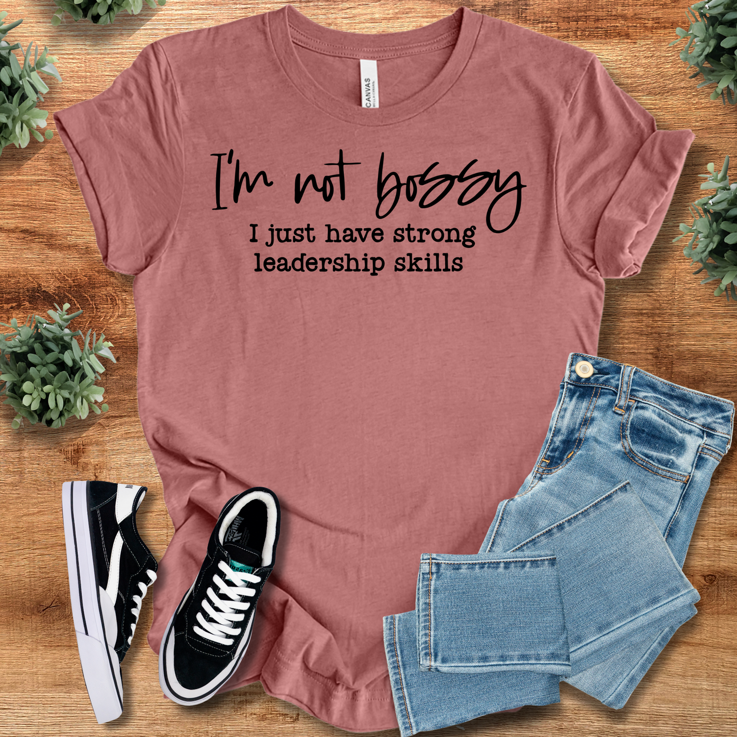 heather mauve t-shirt with '' text, flat lay styled on a wooden surface.