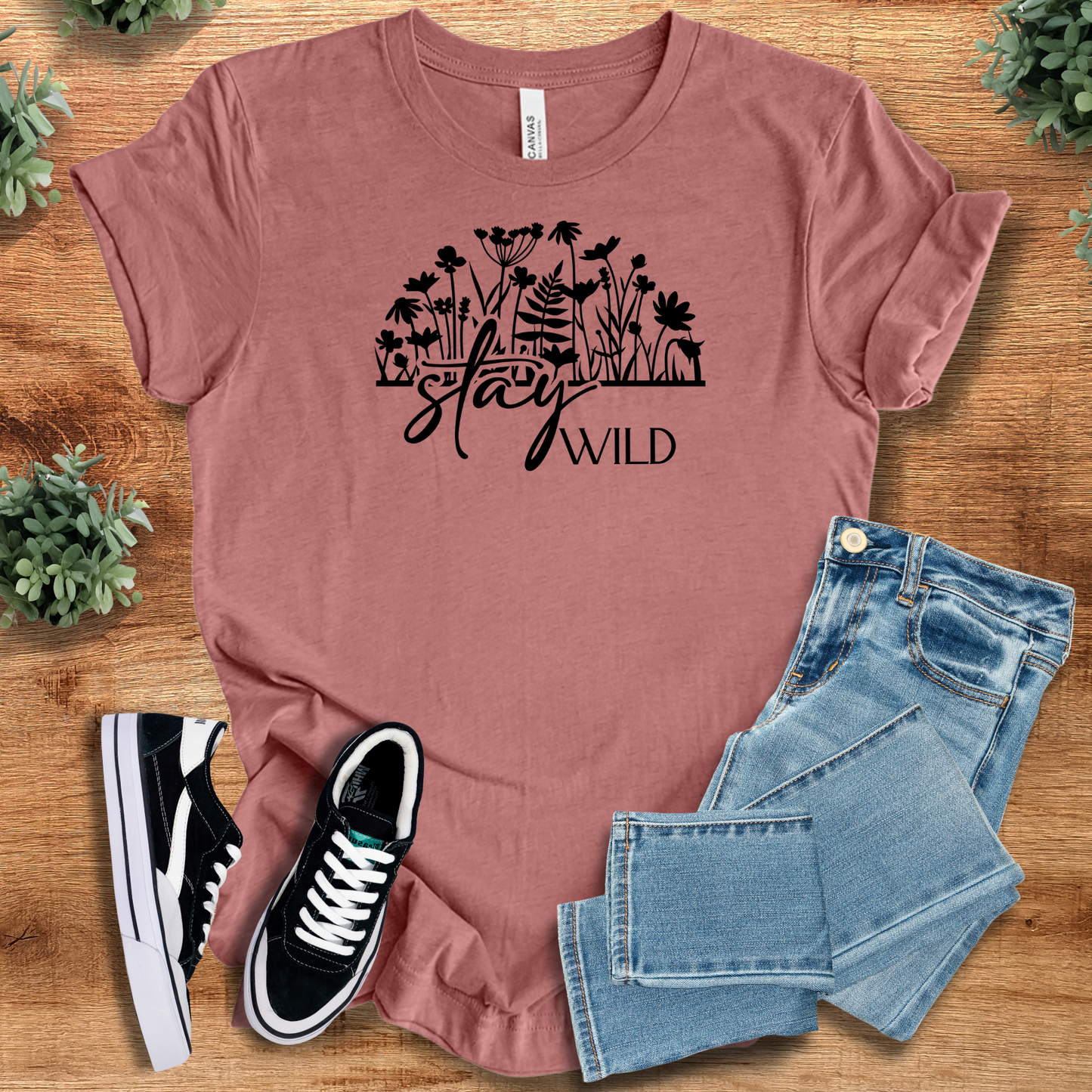 Soft-cream t-shirt with '' text, flat lay styled on a wooden surface.
