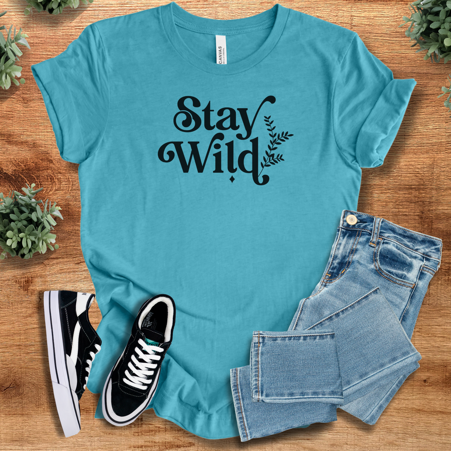Heather-mauve t-shirt with '' text, flat lay styled on a wooden surface.