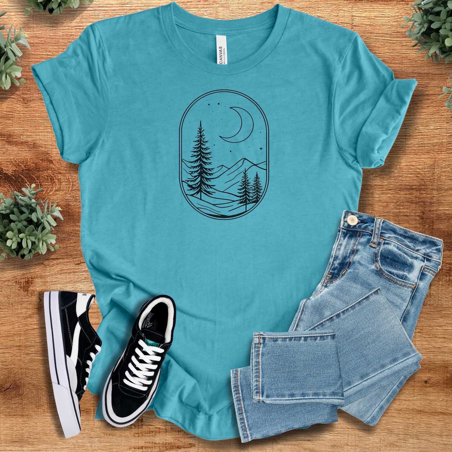 Heather-navy t-shirt with '' text, flat lay styled on a wooden surface.