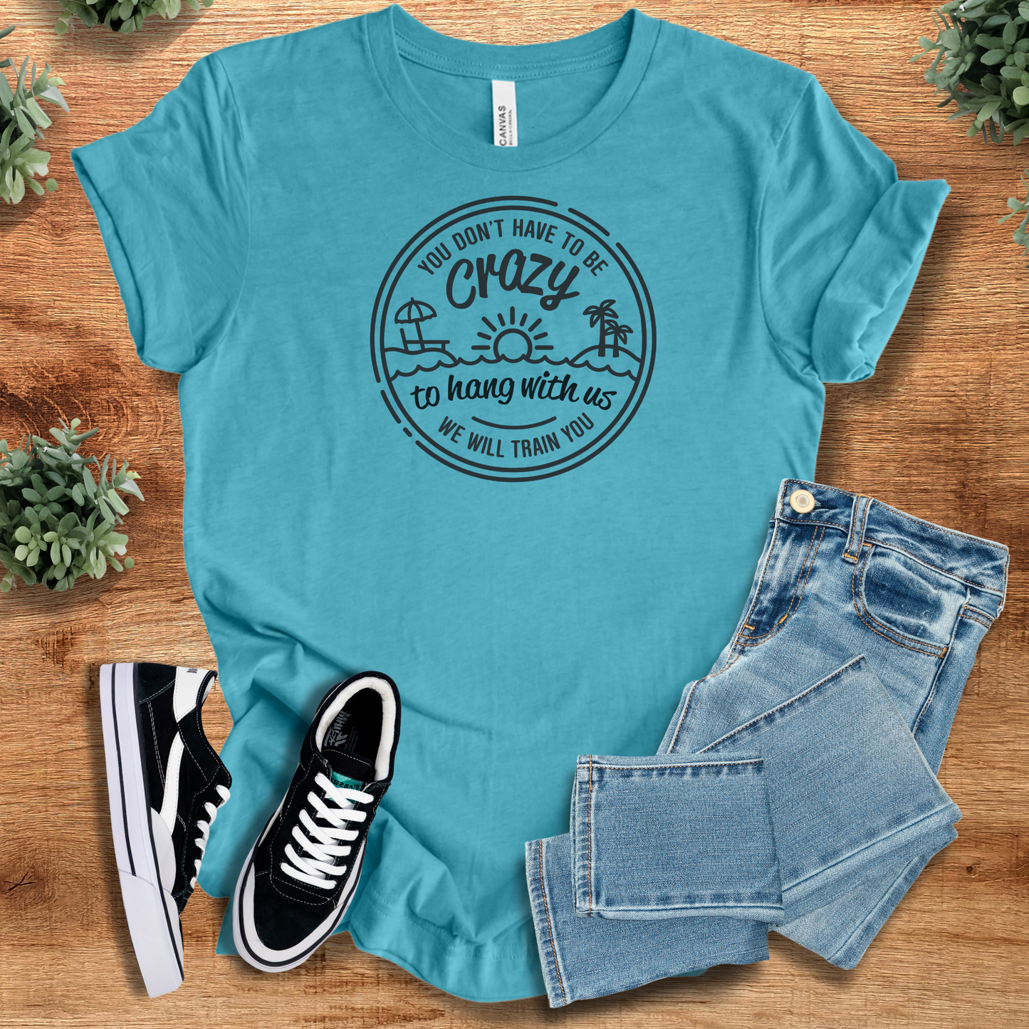 Turquoise funny graphic tee with playful quote and beach icons. Trendy unisex shirt for travel groups or casual adventures.
