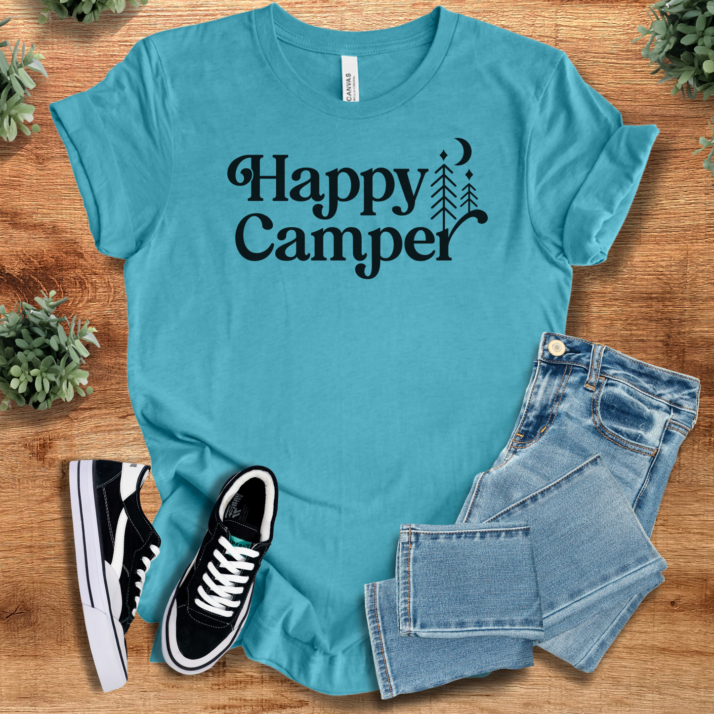 Heather-mauve t-shirt with '' text, flat lay styled on a wooden surface.