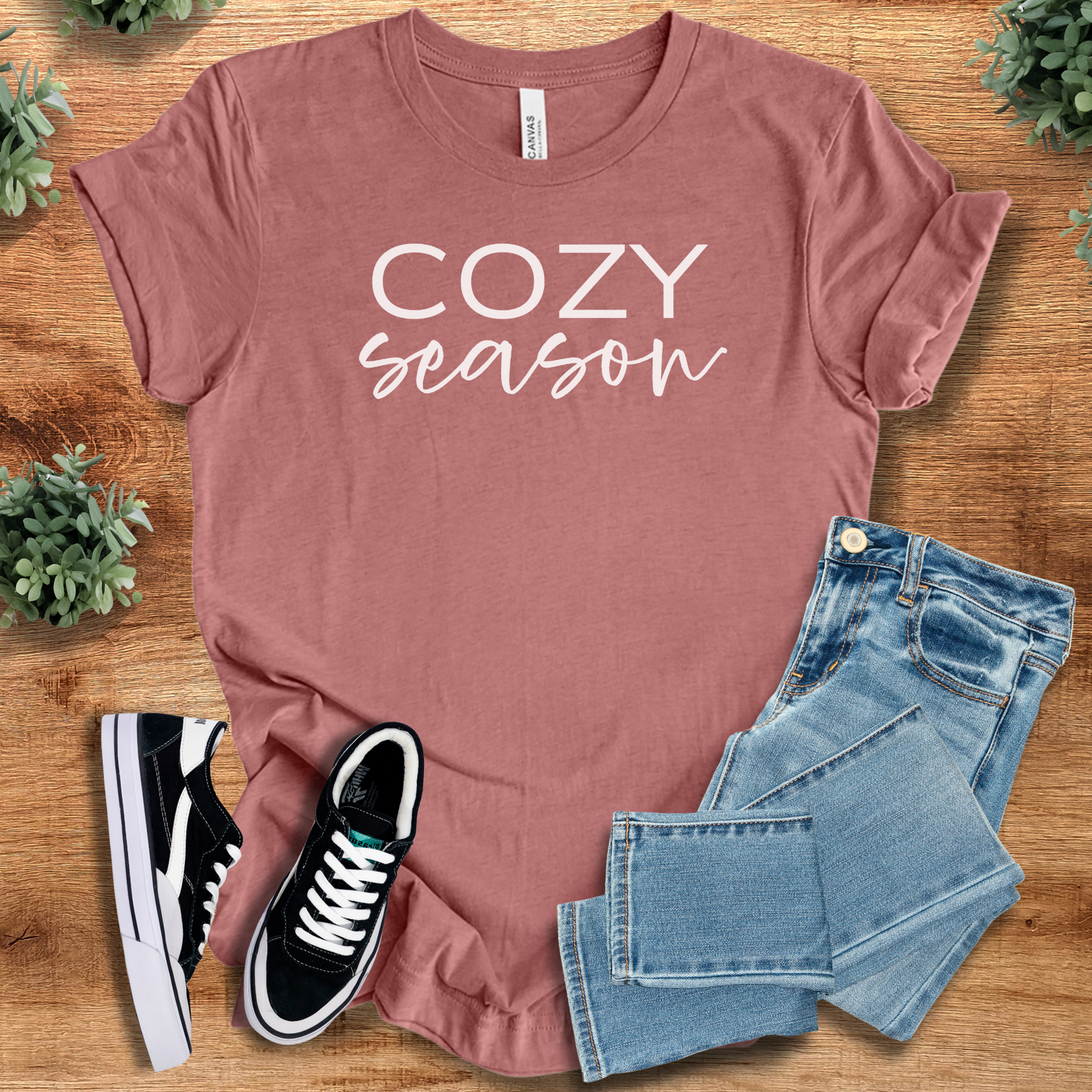 Heather-aqua t-shirt with '' text, flat lay styled on a wooden surface.