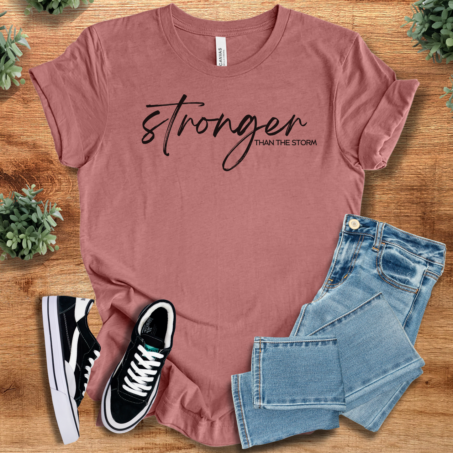 Heather-navy t-shirt with '' text, flat lay styled on a wooden surface.