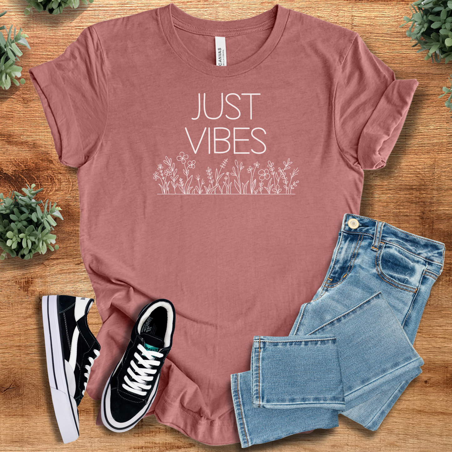Mauve Just Vibes Wildflower T‑Shirt on Bella+Canvas 3001. Minimalist floral graphic tee for uplifting vibes, styled with jeans and sneakers.