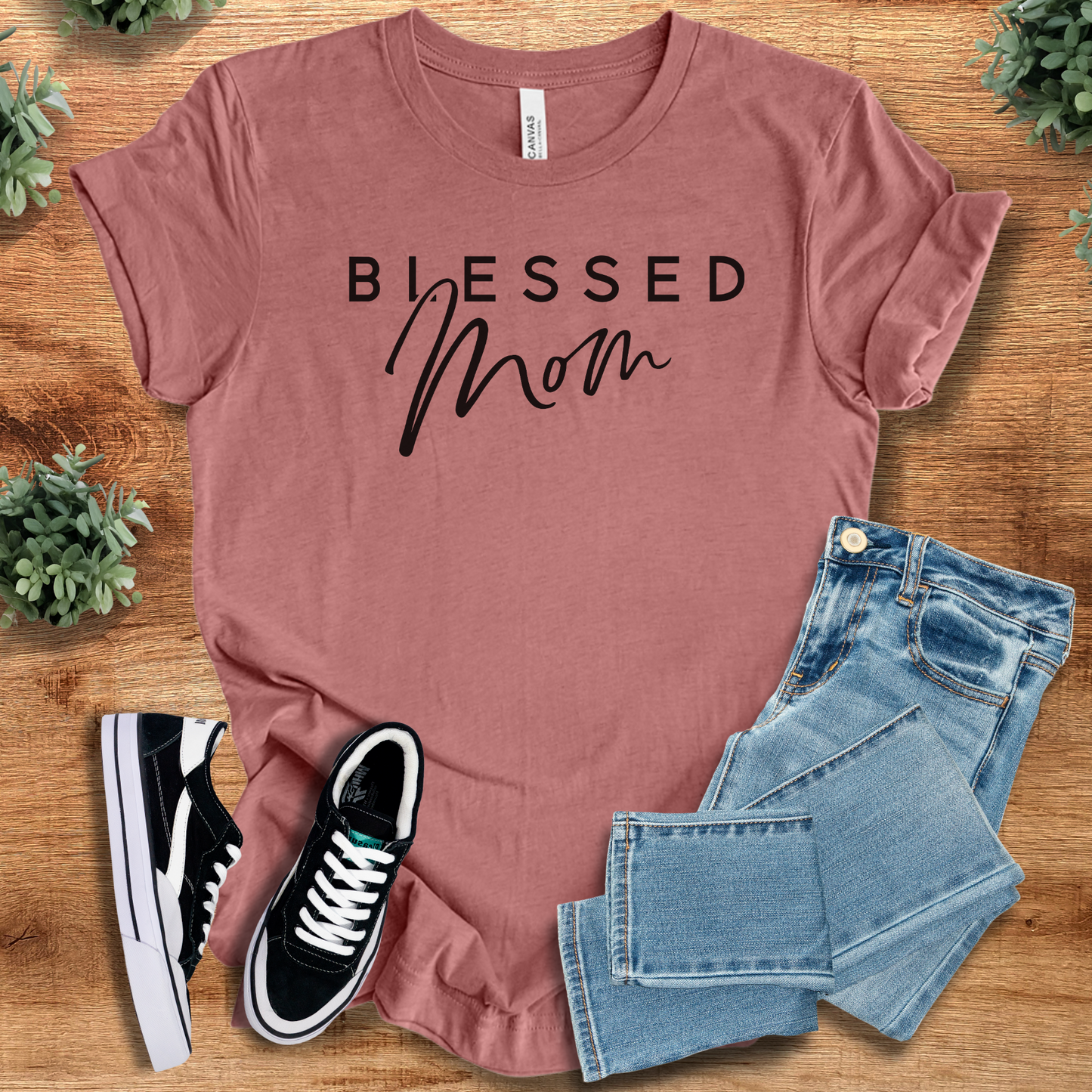 Heather-aqua t-shirt with '' text, flat lay styled on a wooden surface.