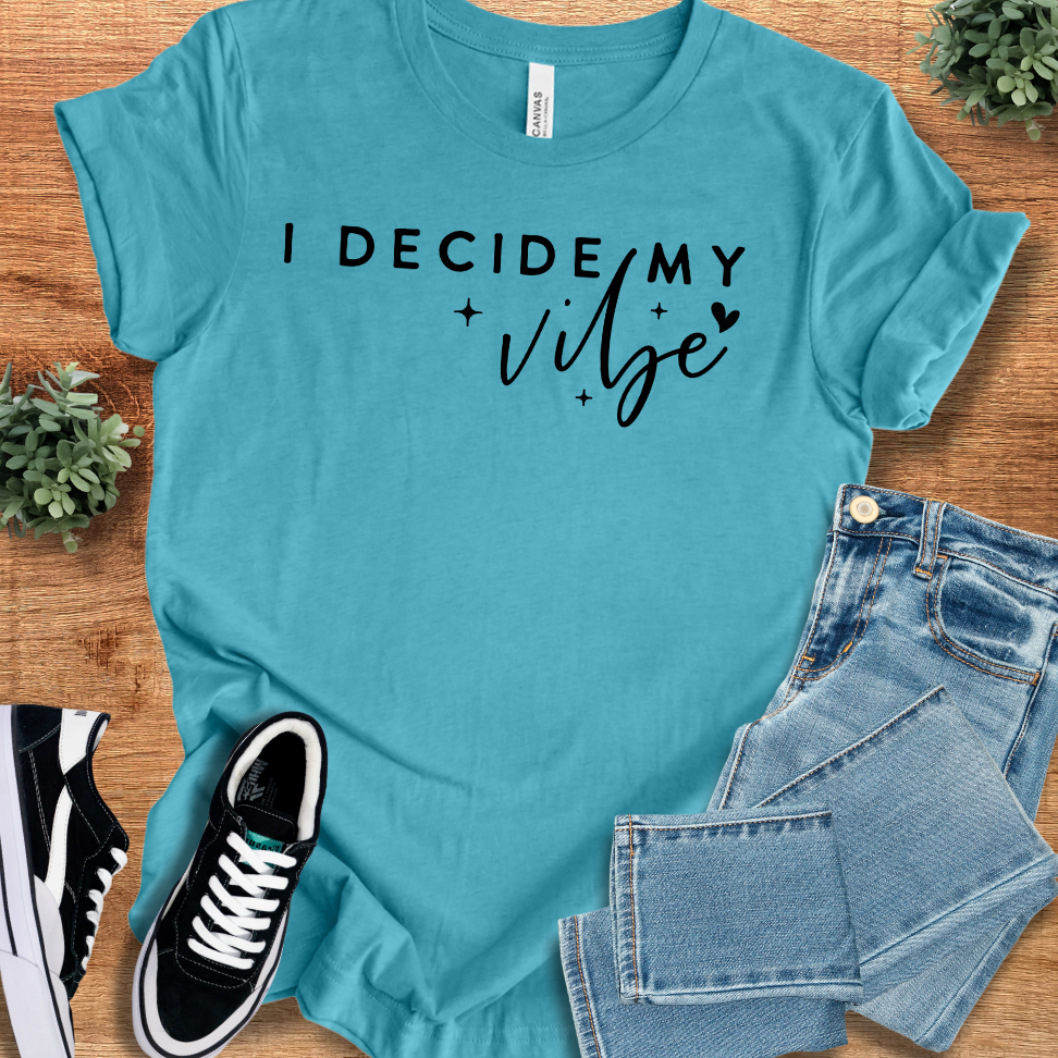 Heather-mauve t-shirt with '' text, flat lay styled on a wooden surface.