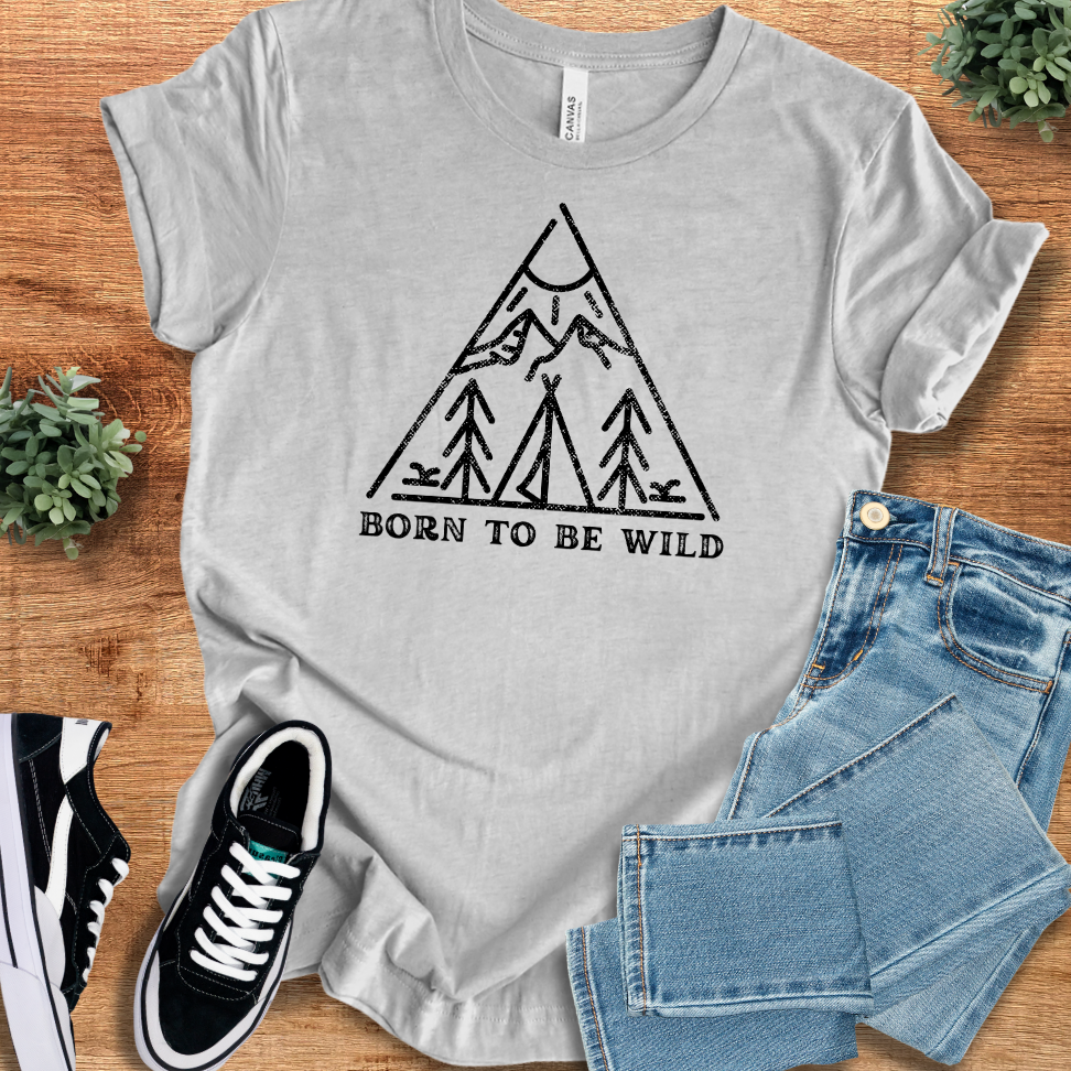 Athletic-heather t-shirt with 'Born To Be Wild T‑Shirt' text, flat lay styled on a wooden surface.