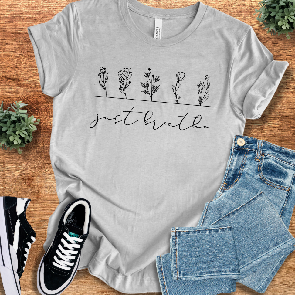 Soft-cream t-shirt with '' text, flat lay styled on a wooden surface.