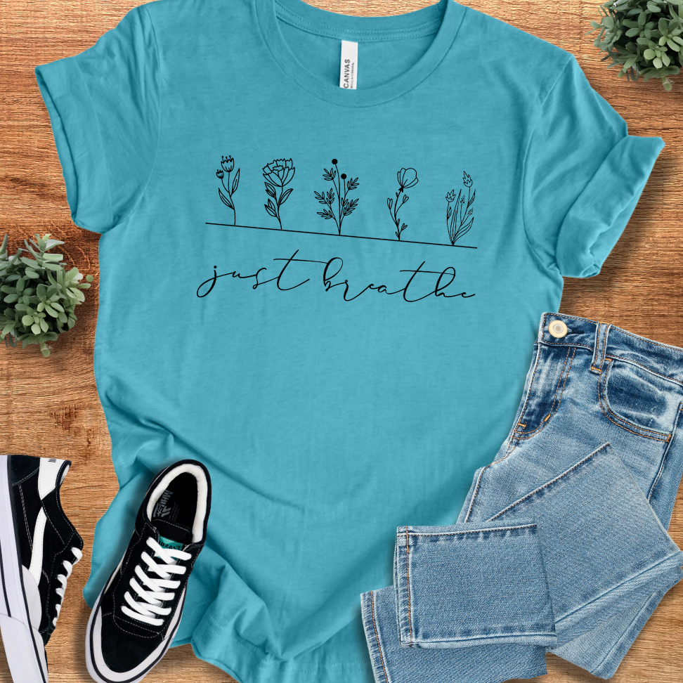 Soft-cream t-shirt with '' text, flat lay styled on a wooden surface.