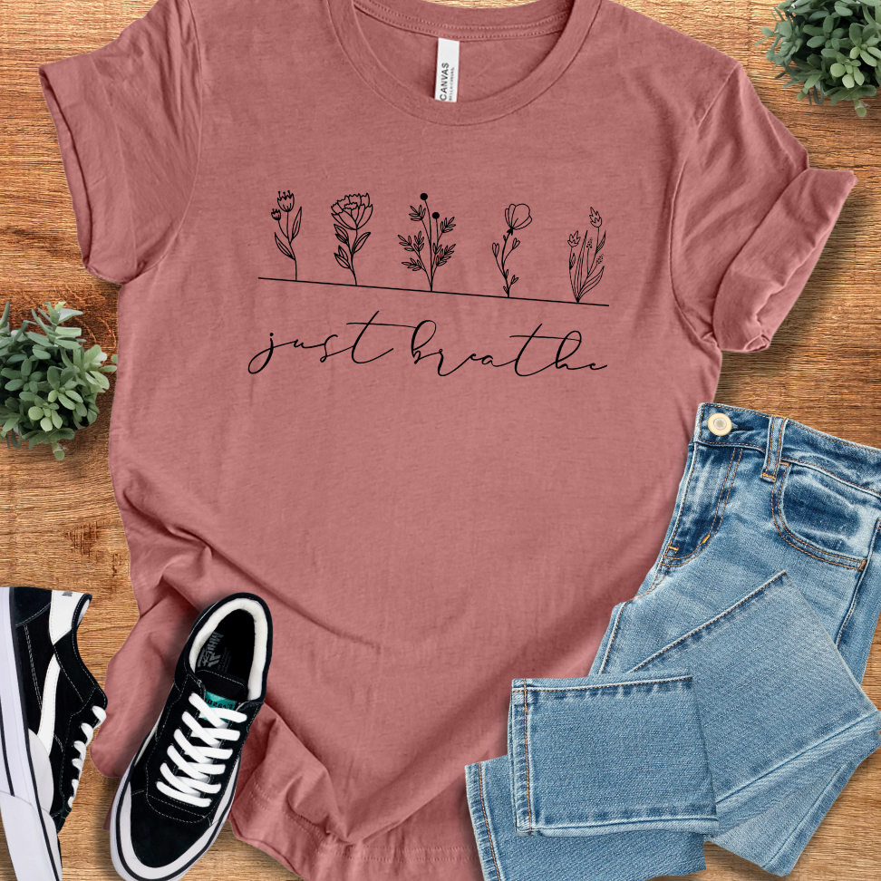 Soft-cream t-shirt with '' text, flat lay styled on a wooden surface.