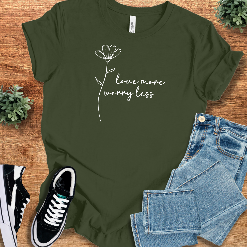 Heather-mauve t-shirt with '' text, flat lay styled on a wooden surface.