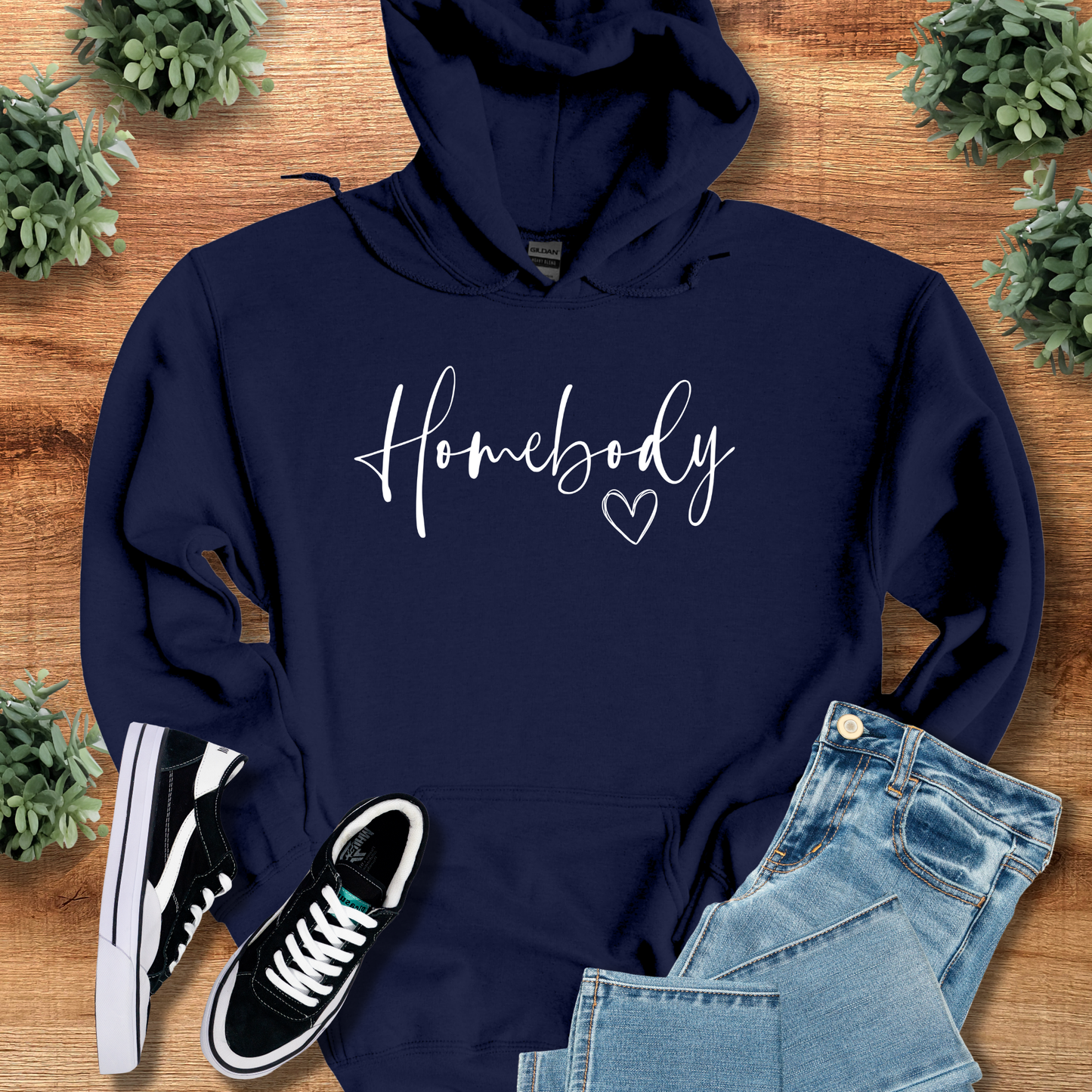 Dark-heather t-shirt with '' text, flat lay styled on a wooden surface.