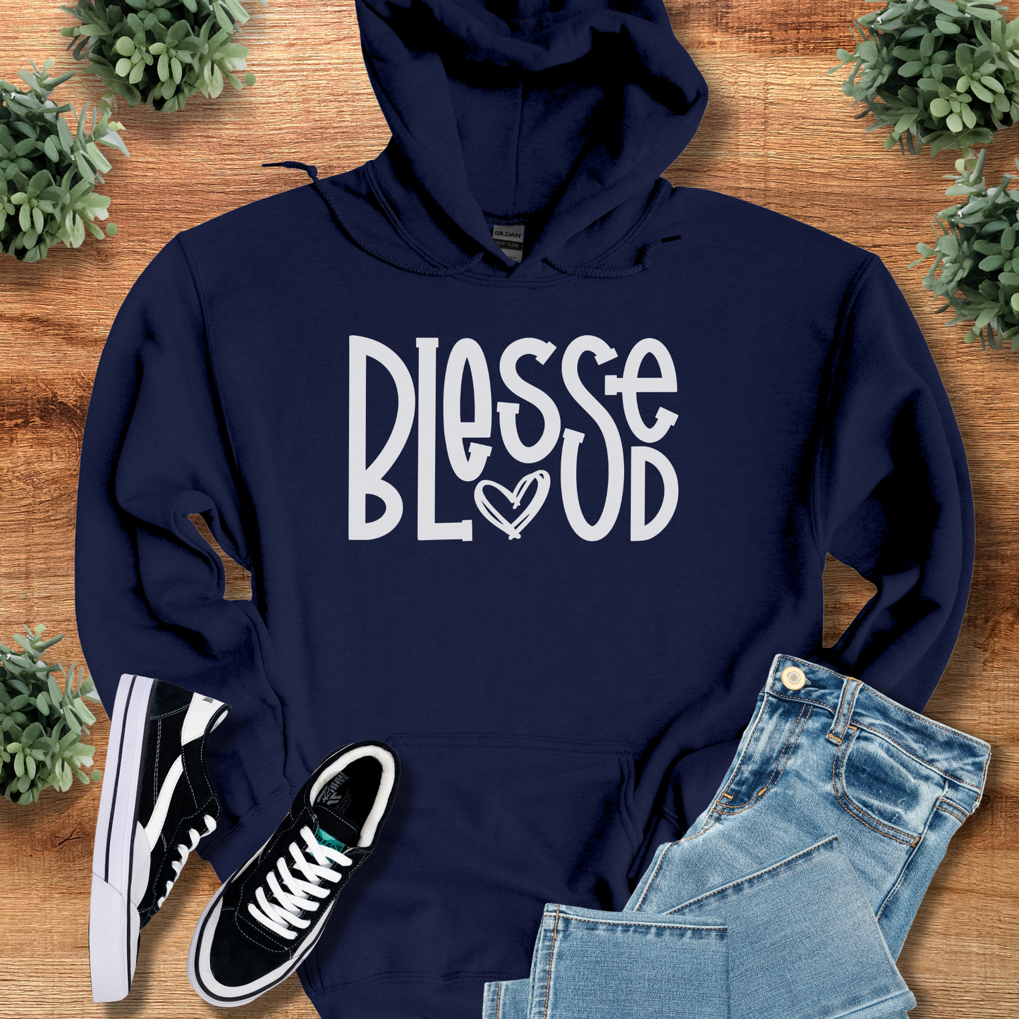 Dark-heather t-shirt with '' text, flat lay styled on a wooden surface.