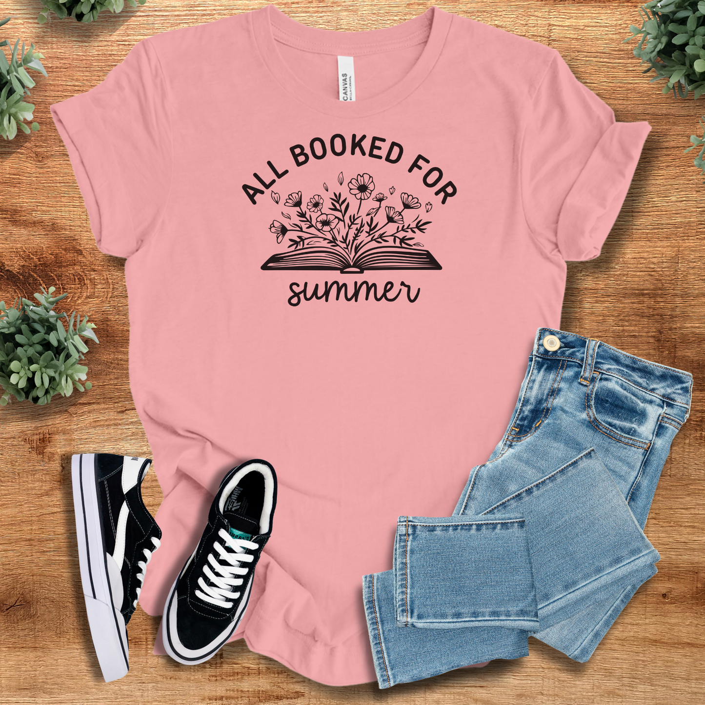 Military Green t-shirt with '' text, flat lay styled on a wooden surface.