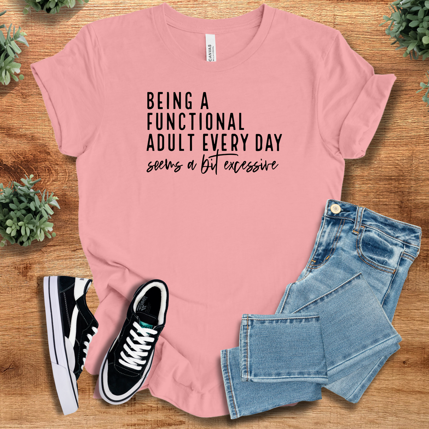 Athletic-heather t-shirt with '' text, flat lay styled on a wooden surface.