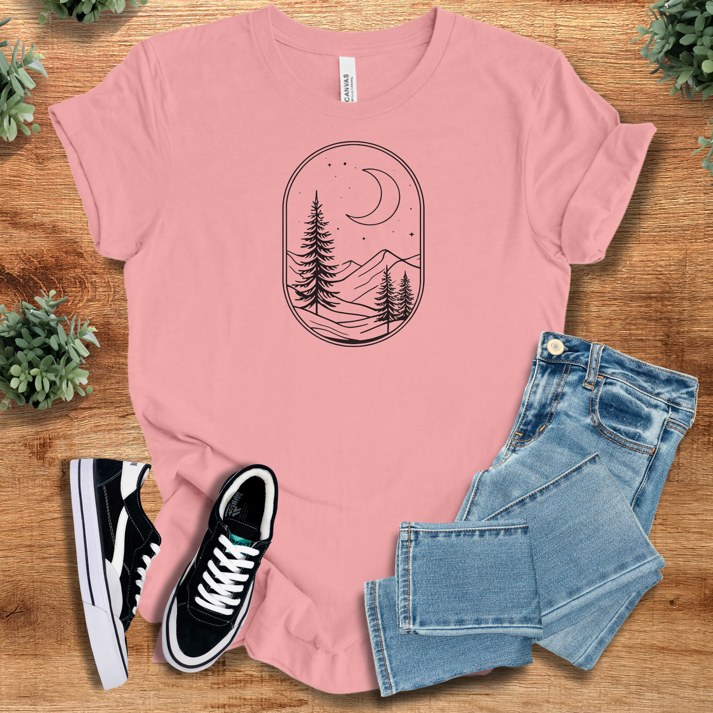 Heather-aqua t-shirt with '' text, flat lay styled on a wooden surface.
