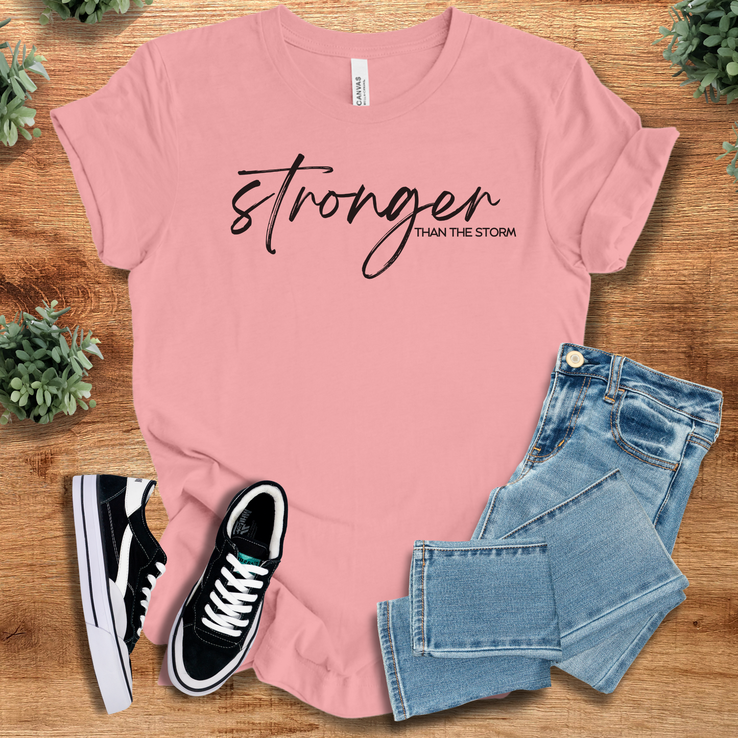 Heather-navy t-shirt with '' text, flat lay styled on a wooden surface.